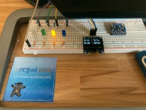 Breadboard with lit yellow LED and Display